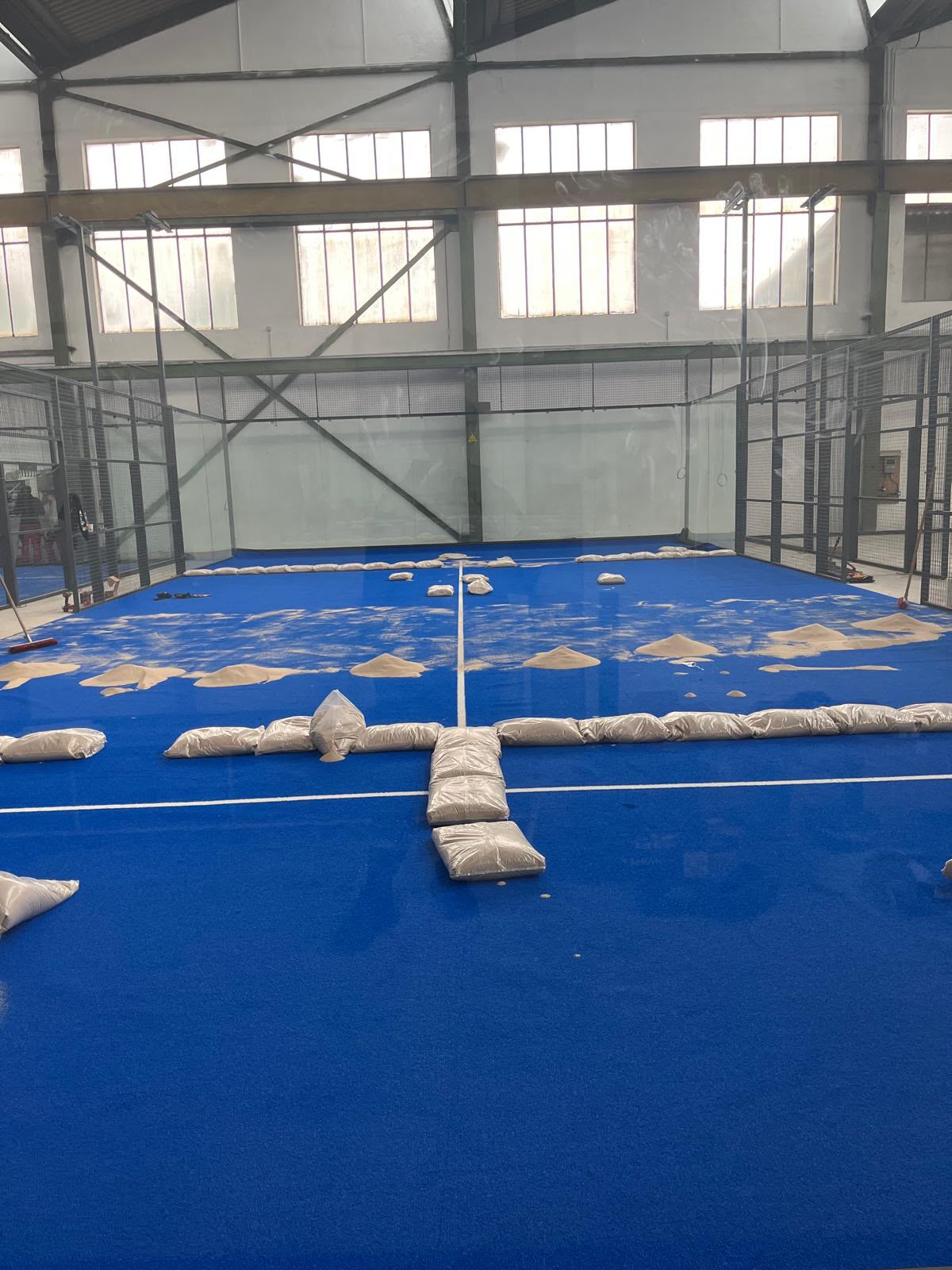 Blue court turf during installation